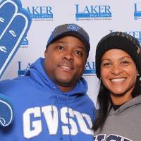 Husband and wife holding laker gear